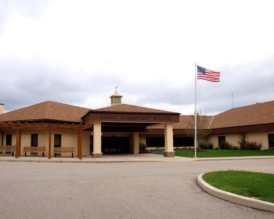 An american flag is flying in front of a large building