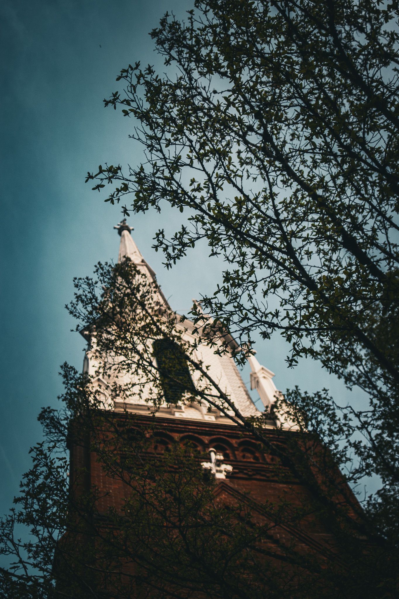 Tall spire of Salem First United Methodist Church rising above downtown Salem Oregon, showcasing historic Gothic Revival church architecture.