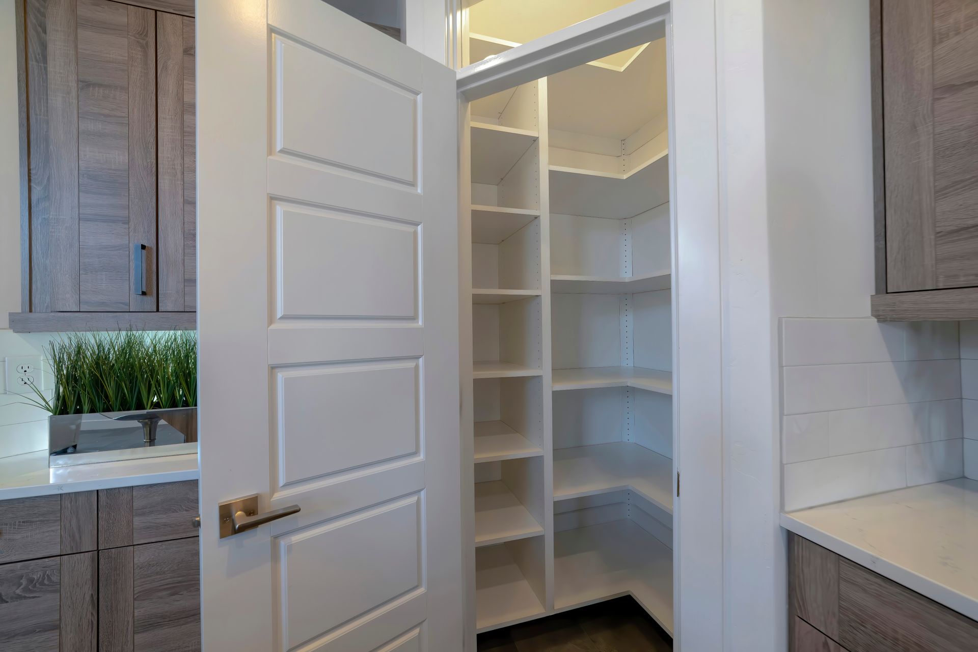 custom walk-in pantry with white shelving inside