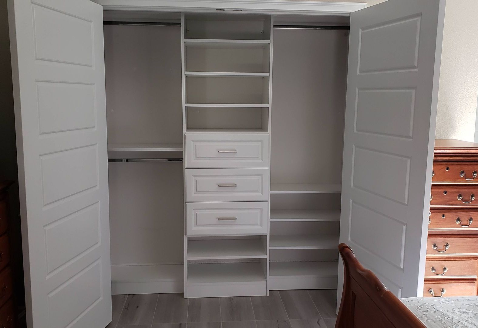 white reach in closet with drawers and space for hanging