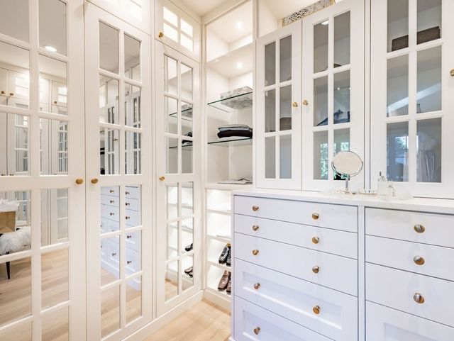white custom closet with mirrored glass panels
