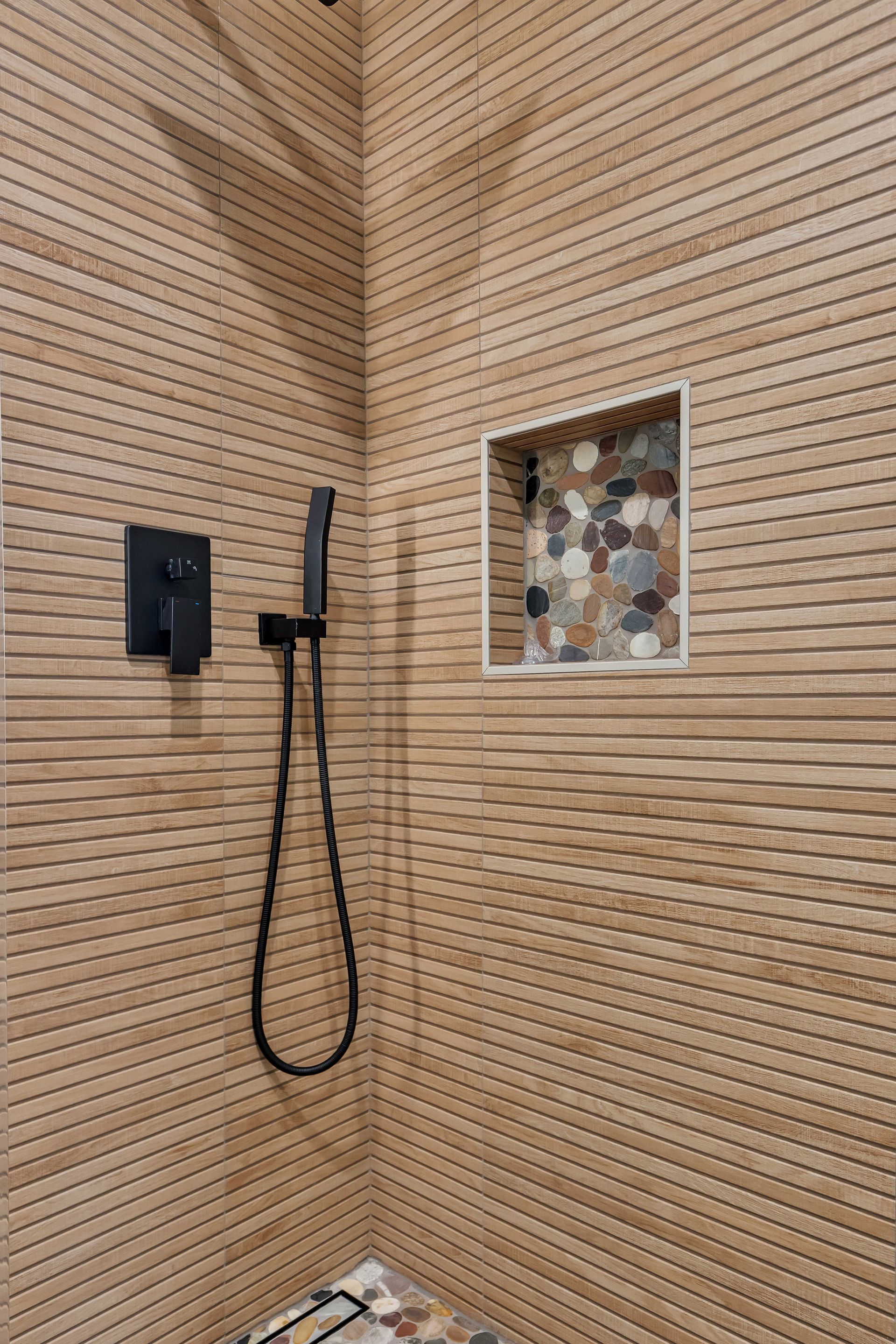 Shower with tan wall.