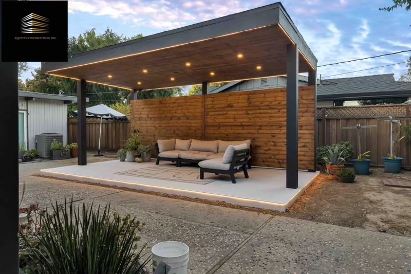 Modern kitchen with marble countertops, wood cabinets, stainless steel appliances, and pendant lighting.