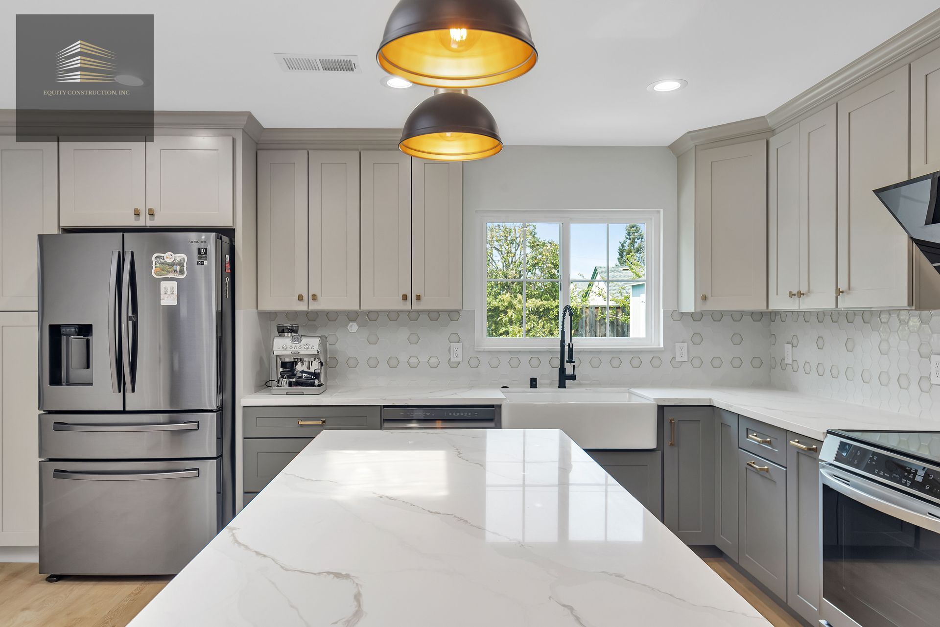 Living room with a mounted TV, white sofa, and a large window overlooking a yard.