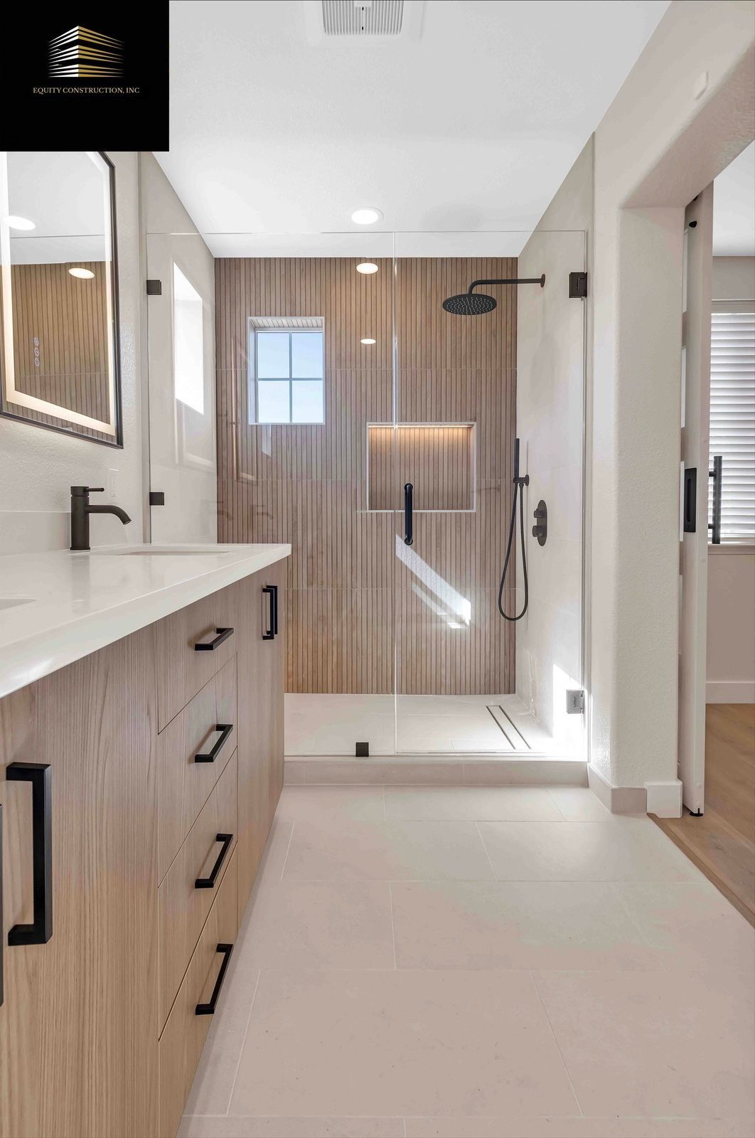 Modern bathroom with wood-look shower wall, glass door, white countertop, and light wood vanity.