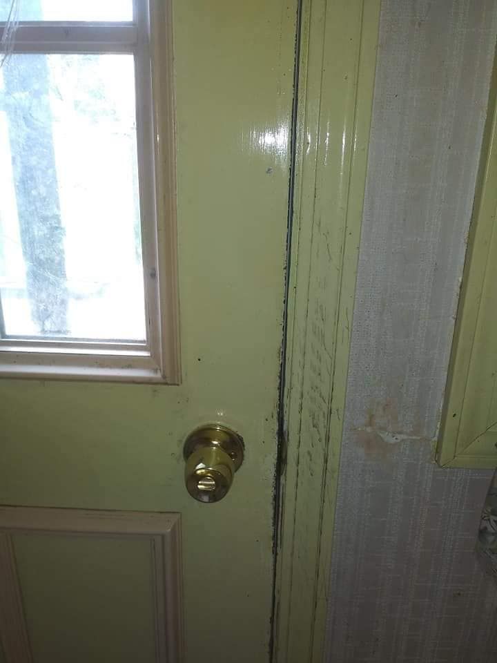 A close up of a door with a window and a door knob.