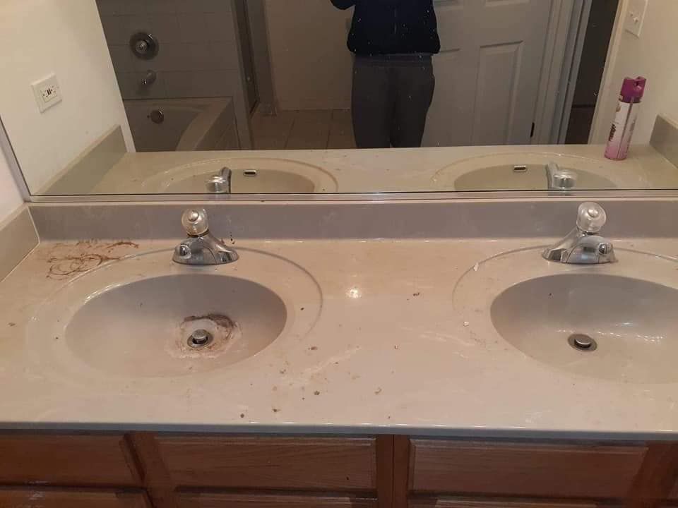 A door with mold growing on it and a window.