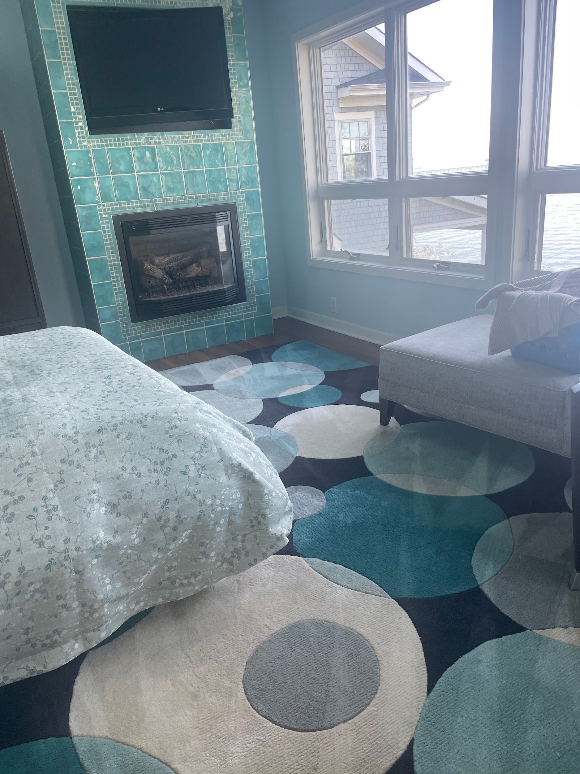 A living room with a fireplace and a flat screen tv.