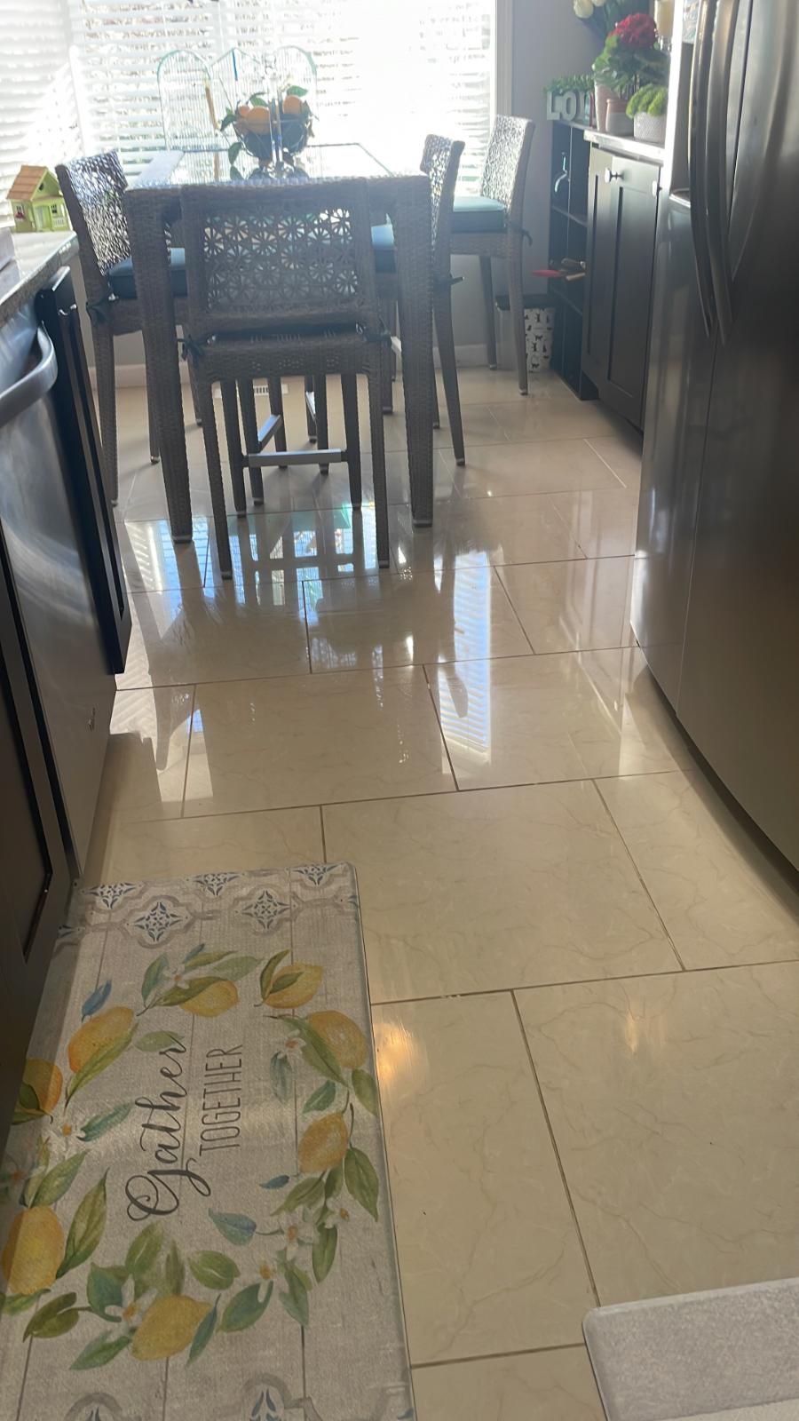 A kitchen with a table and chairs and a rug on the floor.