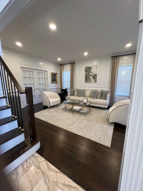 A kitchen with stainless steel appliances and a large island in the middle.