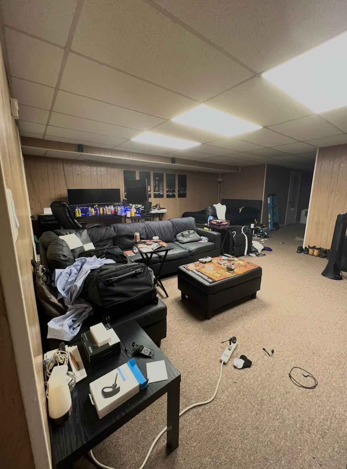A dirty bathtub in a bathroom with a tiled floor.