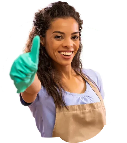A woman wearing an apron and gloves is giving a thumbs up.