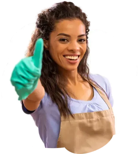 A woman wearing an apron and gloves is giving a thumbs up.