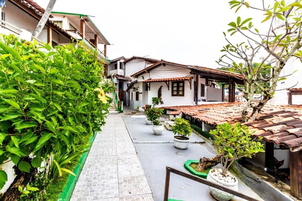 Uma passarela que leva a uma casa branca com telhado de telha vermelha