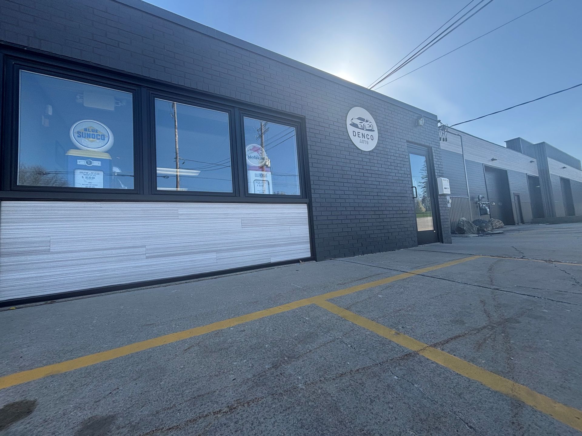 A large building with a lot of windows and a parking lot in front of it.