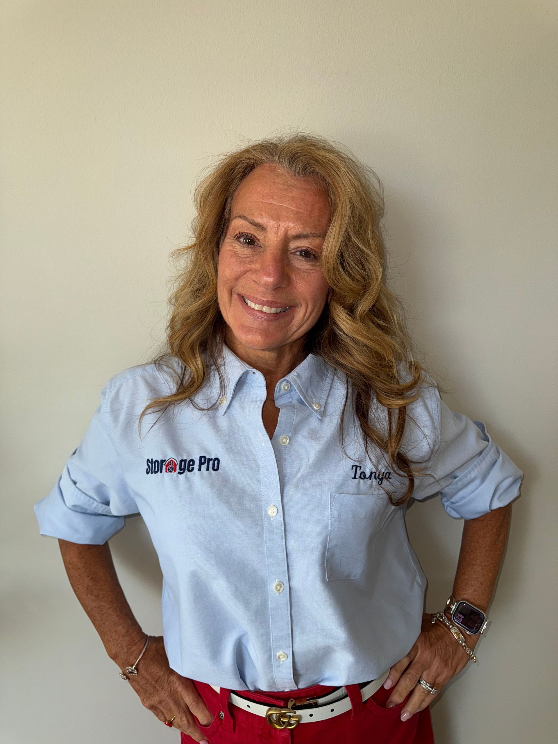 A man and a woman are posing for a picture in front of a window.