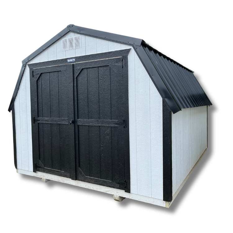 A white barn with black doors and a black roof