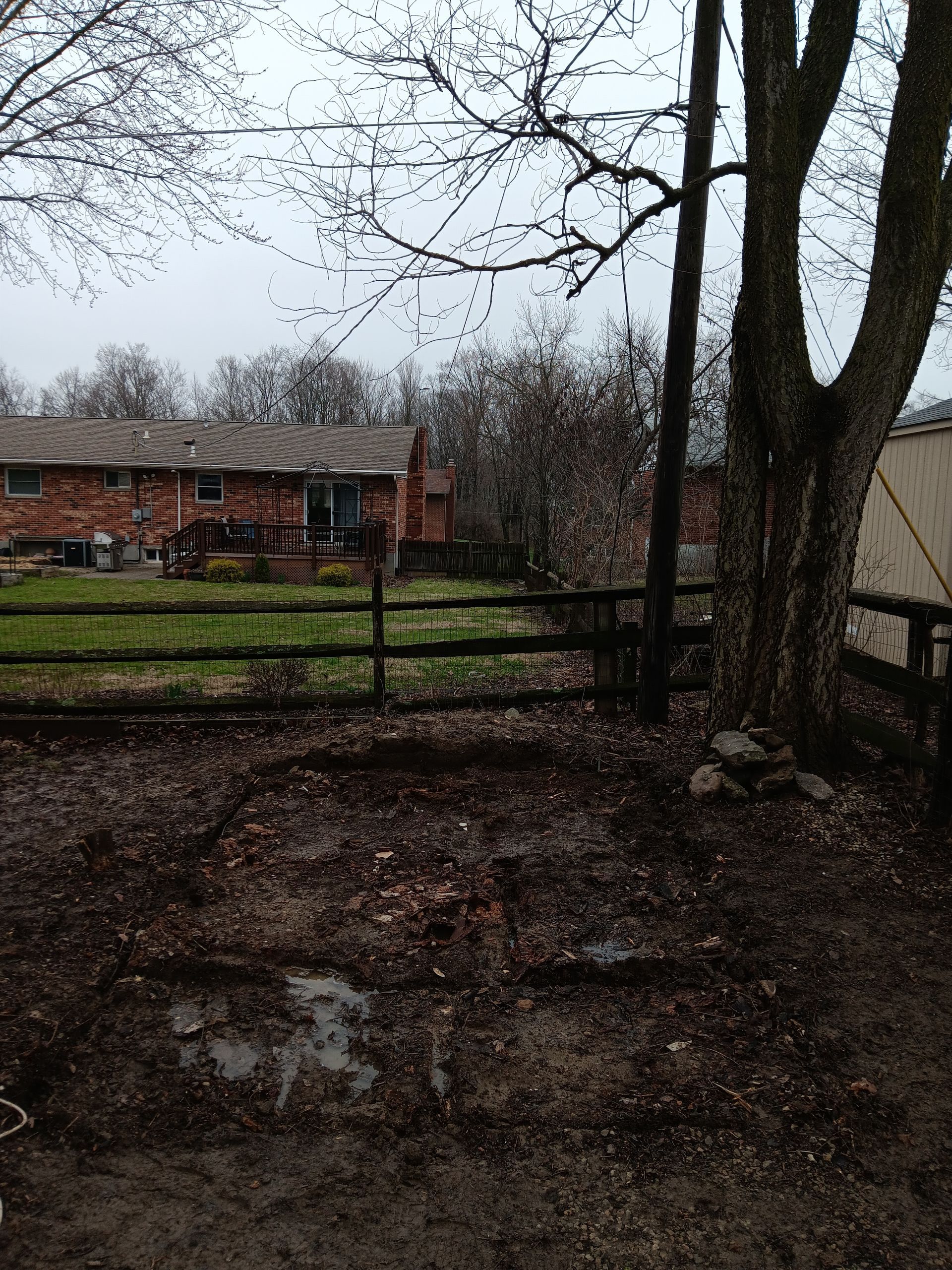 A fenced in yard with a house in the background