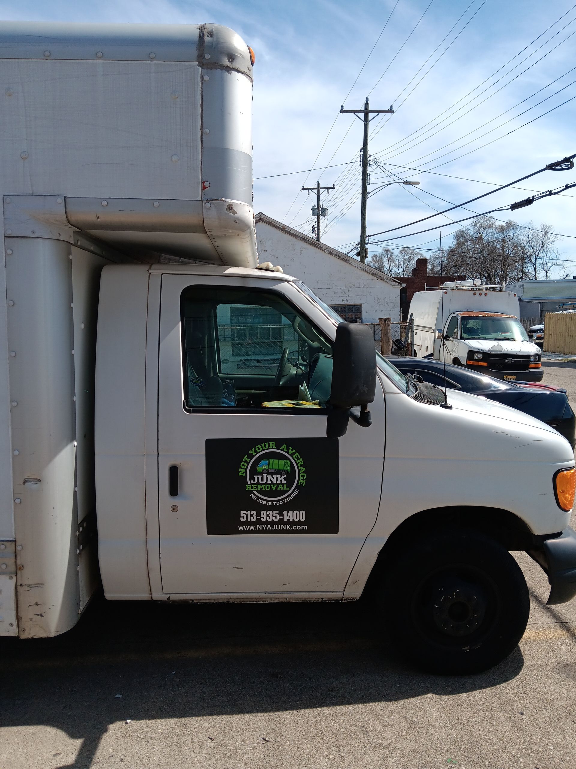 A white truck is parked on the side of the road.