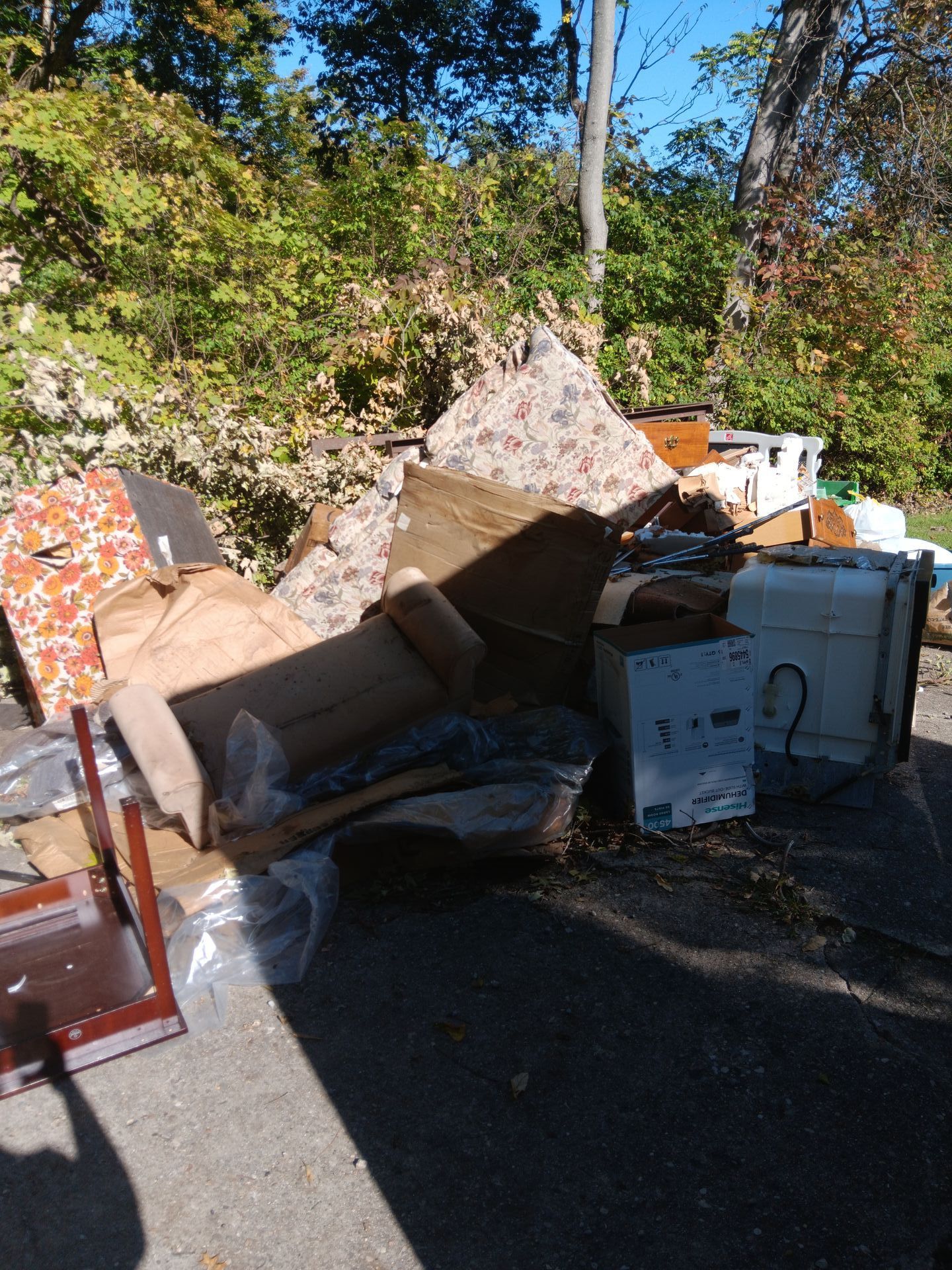 A pile of junk is sitting on the side of the road.