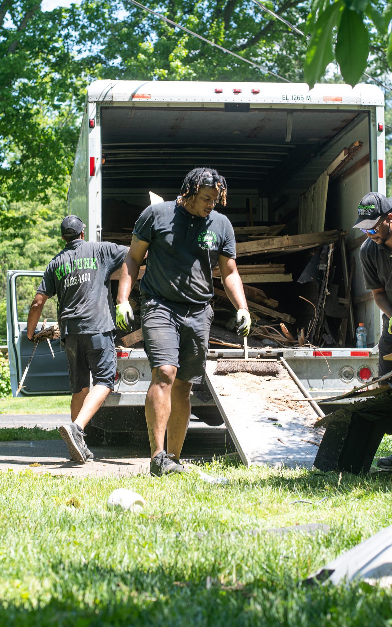 A group of men are loading wood into a truck.