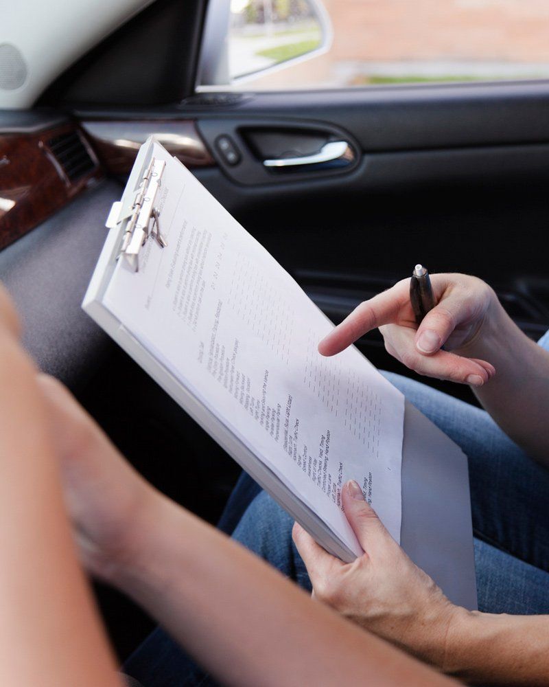 Instructor Holding Driving Test Checklist - Northgate Driving School - Rochester, MN