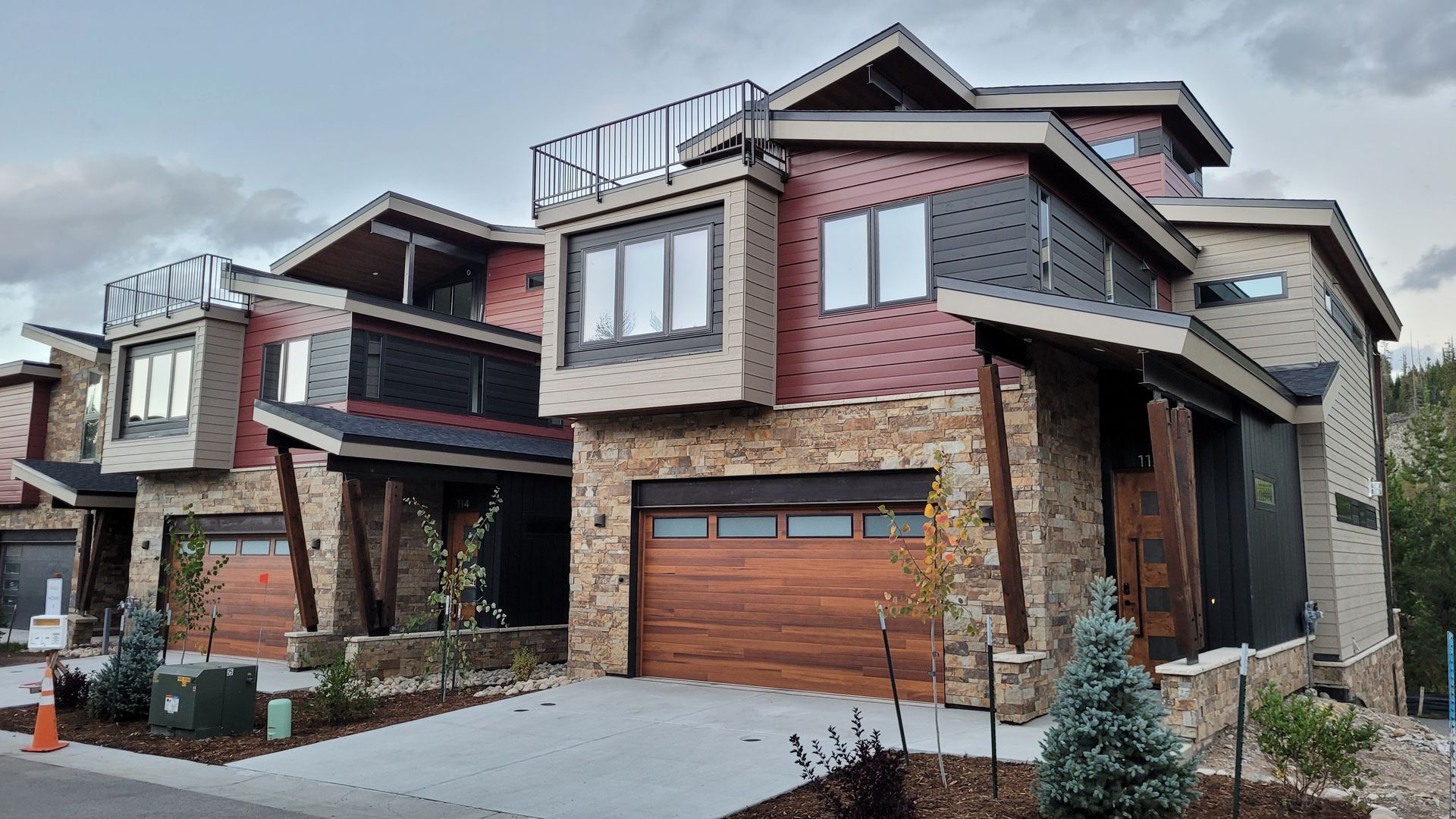 A large house with a lot of windows and a wooden garage door.