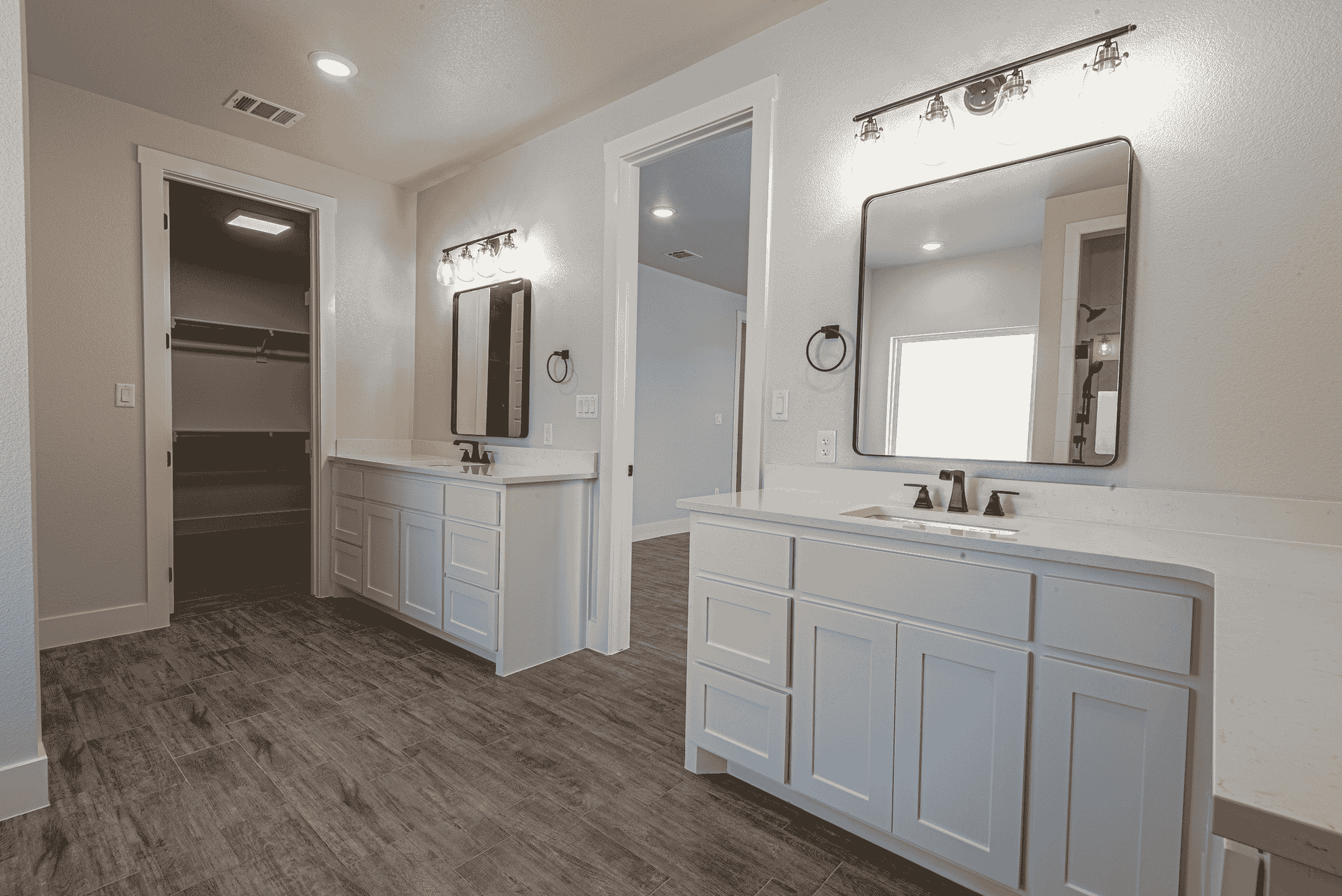 A bathroom with two sinks and two mirrors.