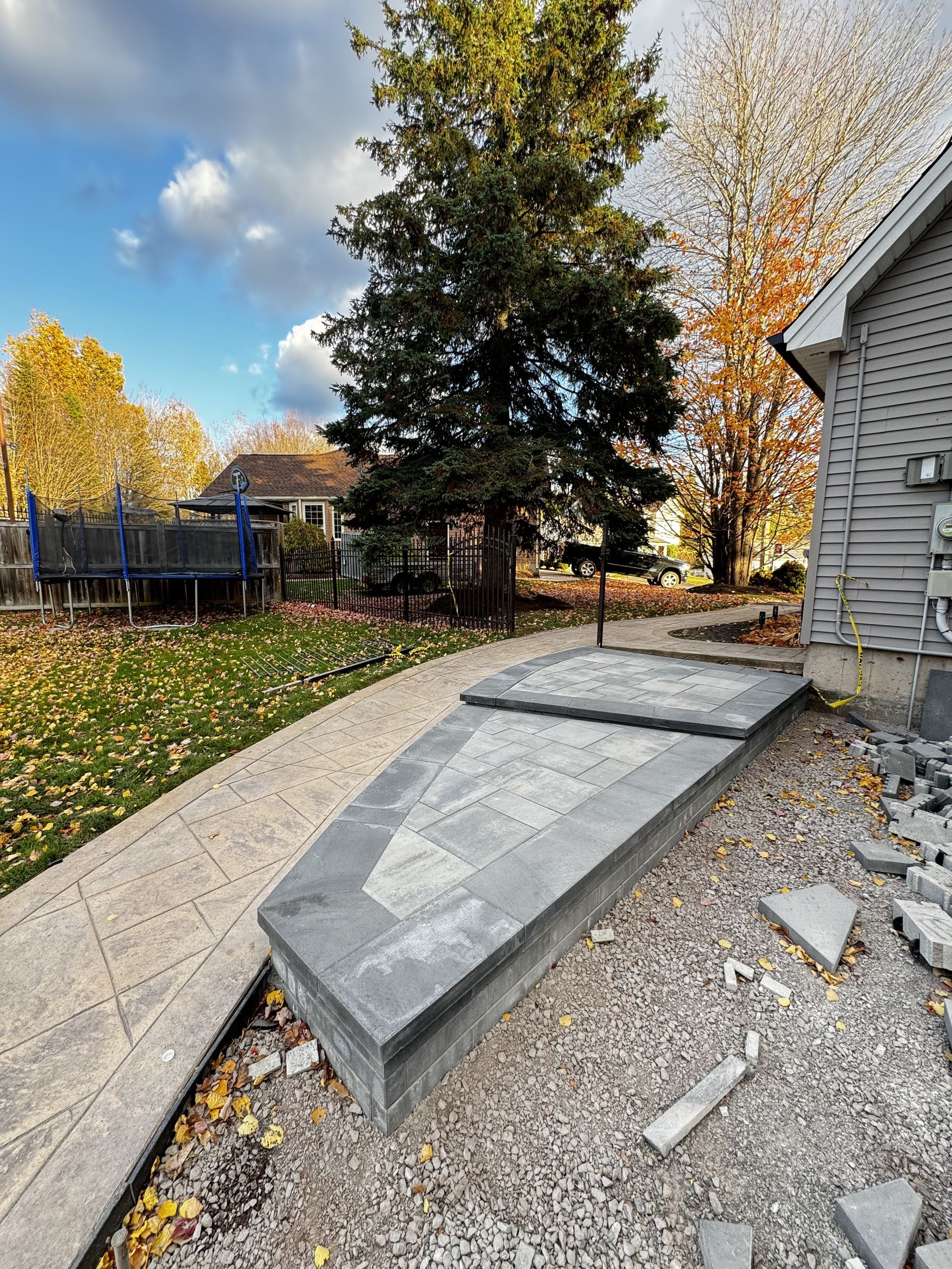 A concrete ramp is being built in front of a house.