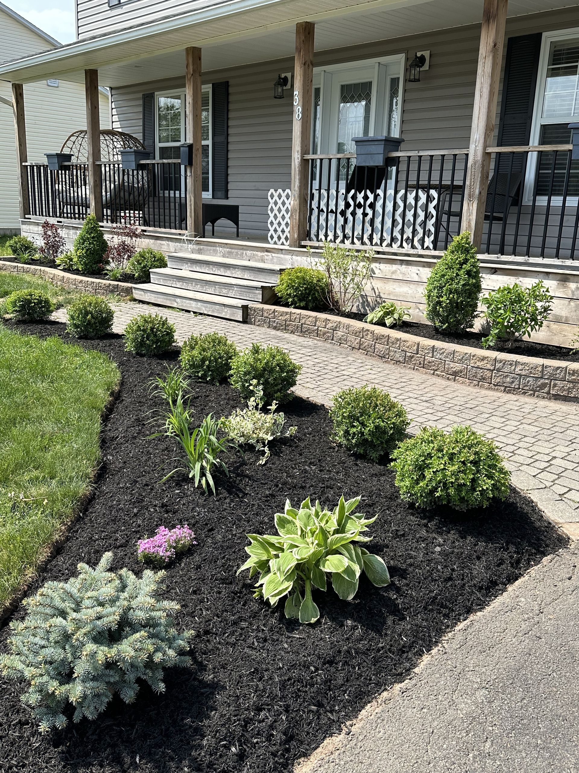A house with a porch and a walkway leading to it.