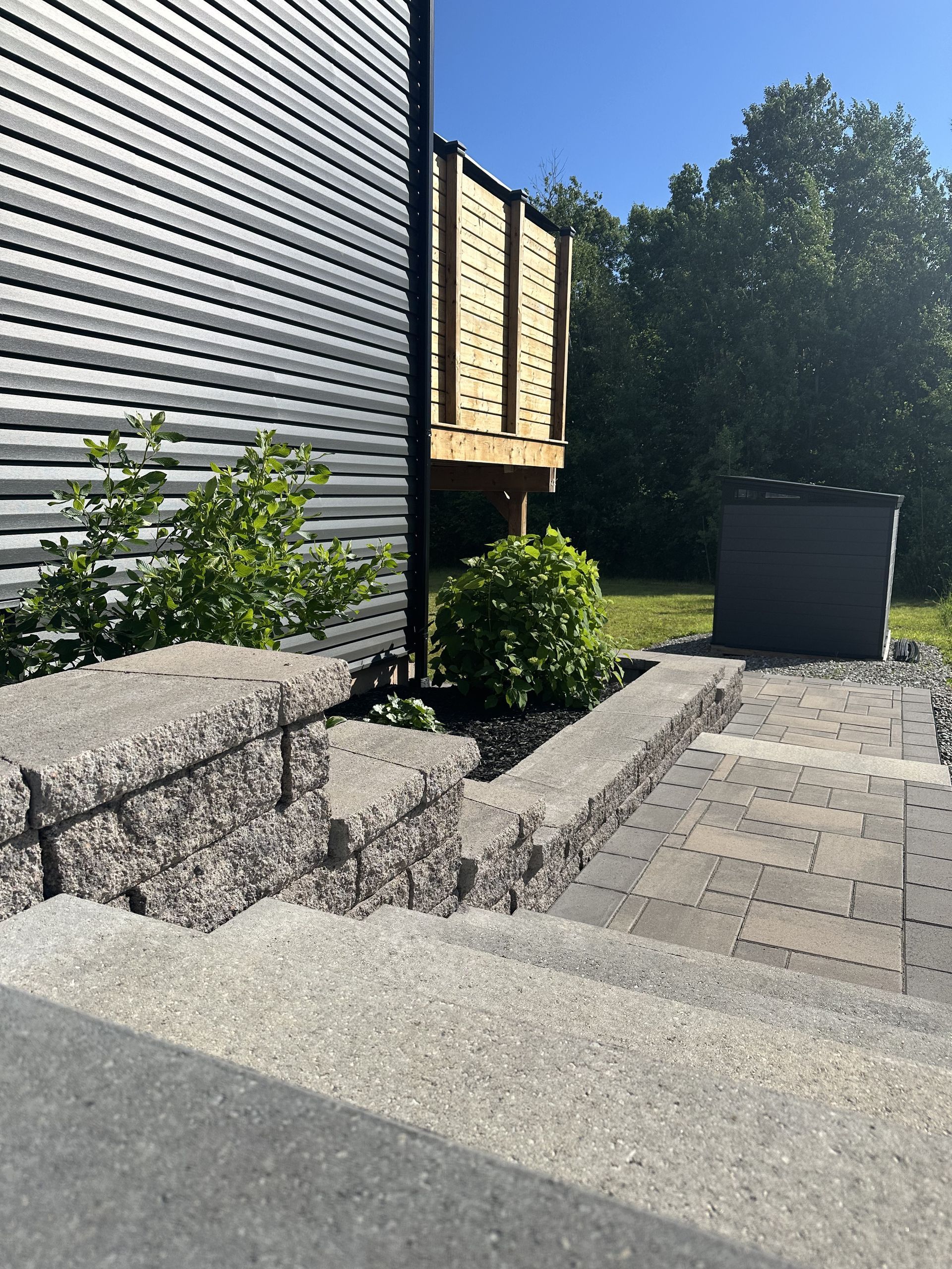 A staircase leading up to a deck next to a house.