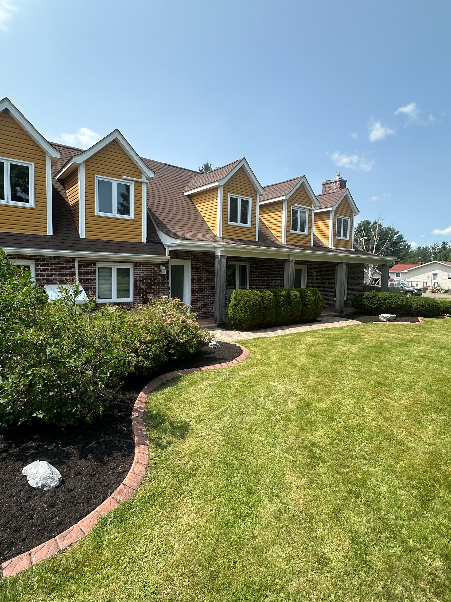 A large house with a large lawn in front of it.