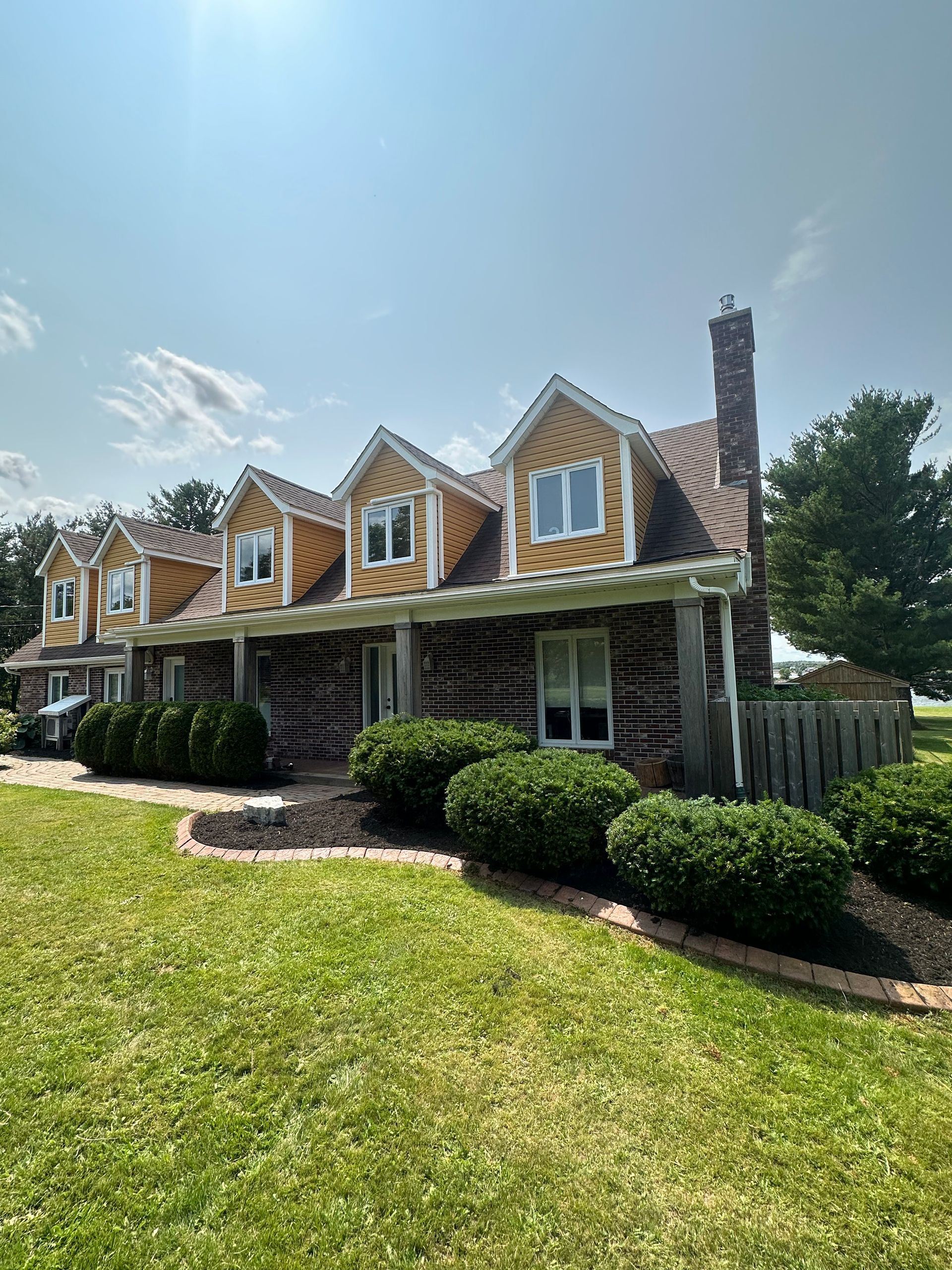 A large log cabin sitting on top of a lush green field.