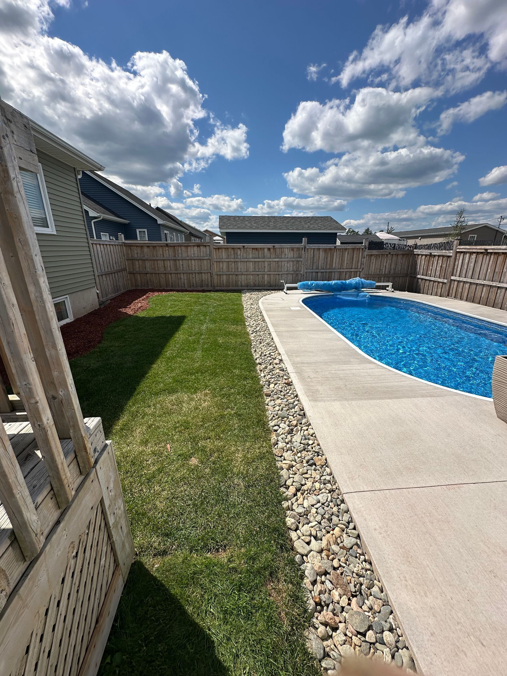 A large swimming pool in the backyard of a house