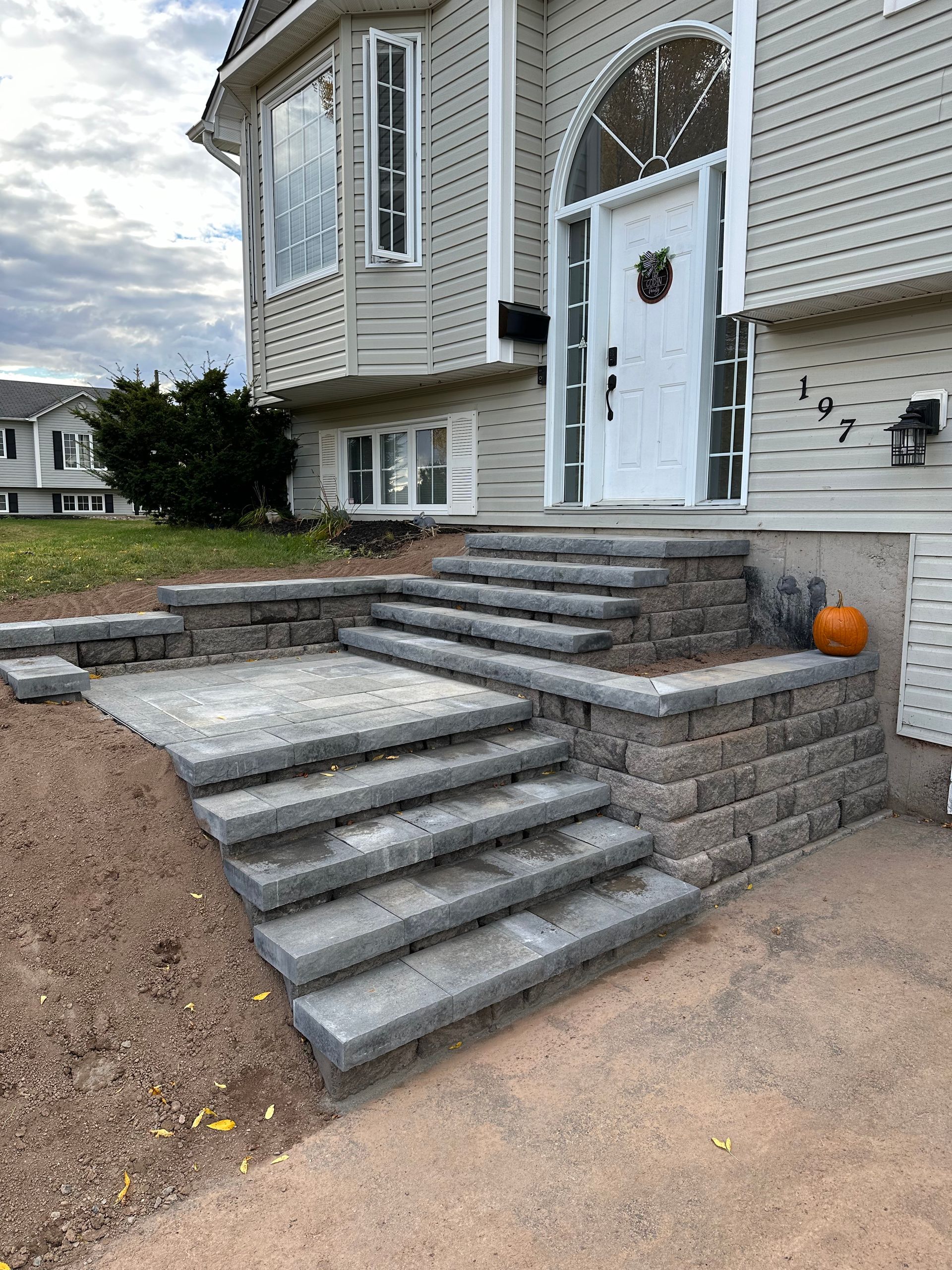 A set of stairs leading up to the front door of a house.