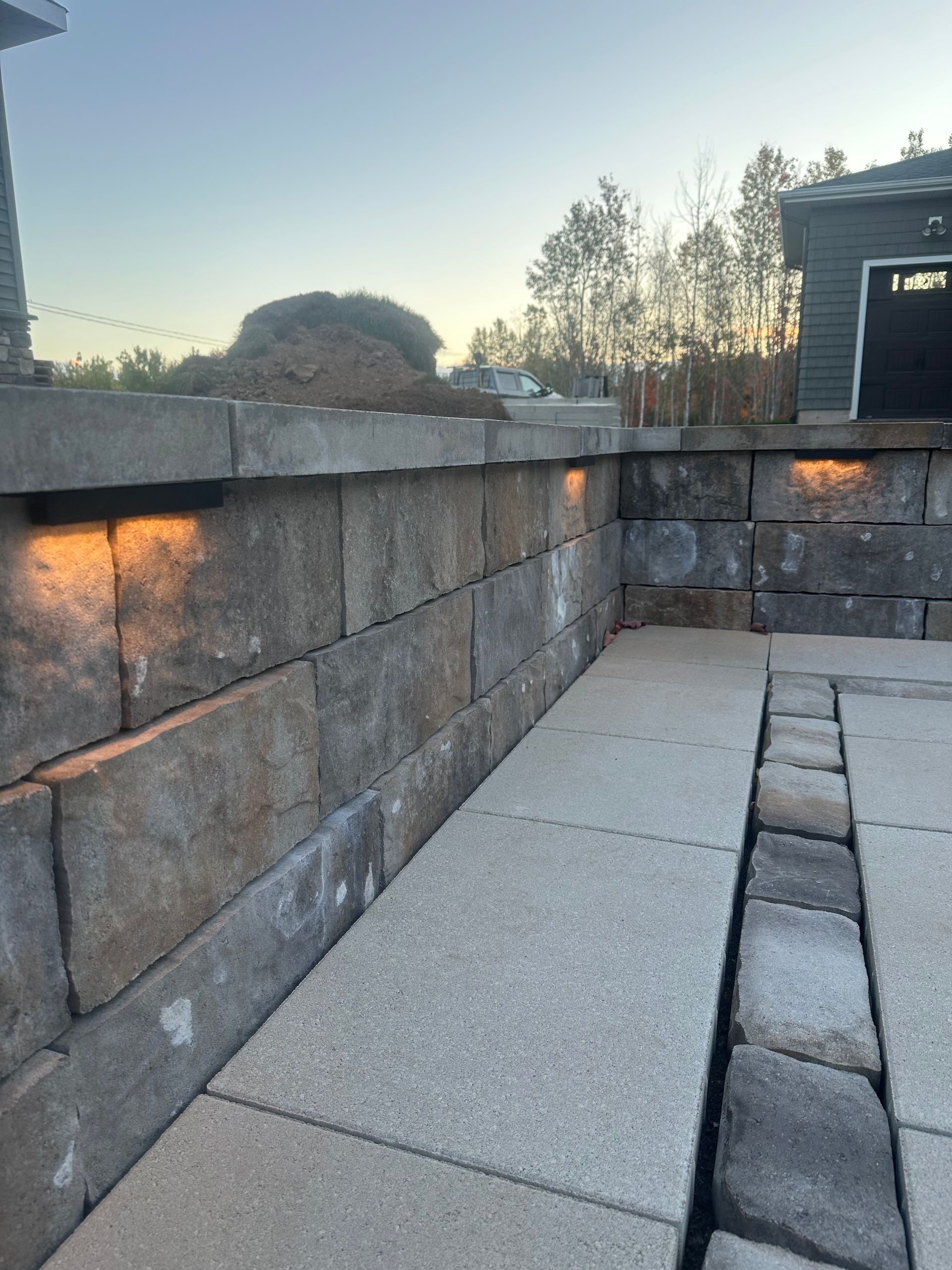 A brick wall with a tree in the background