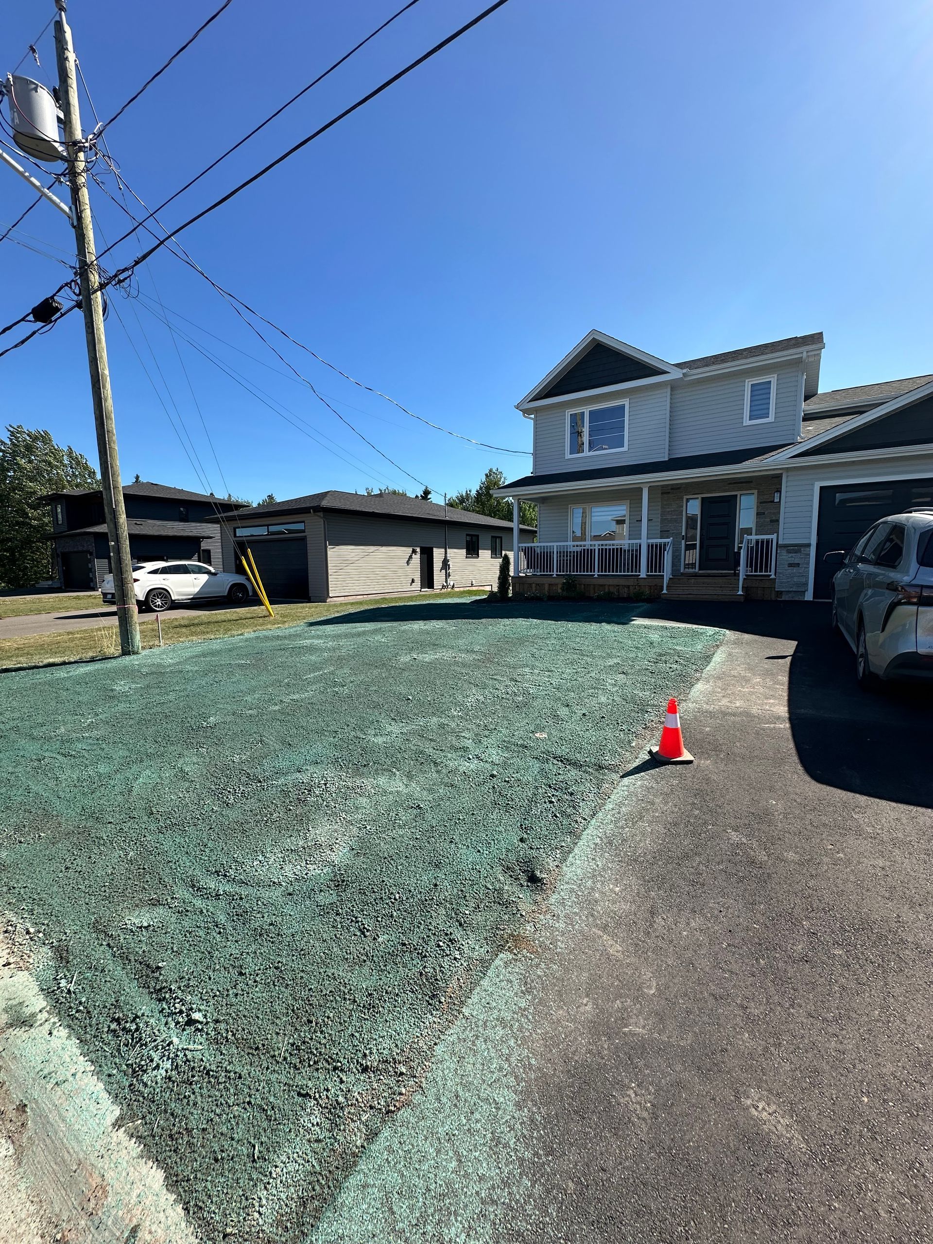 A stone wall with flowers in front of a house.