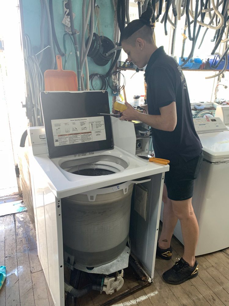 Technician Fixing Washing Machine — Appliance Repair in The Entrance, NSW