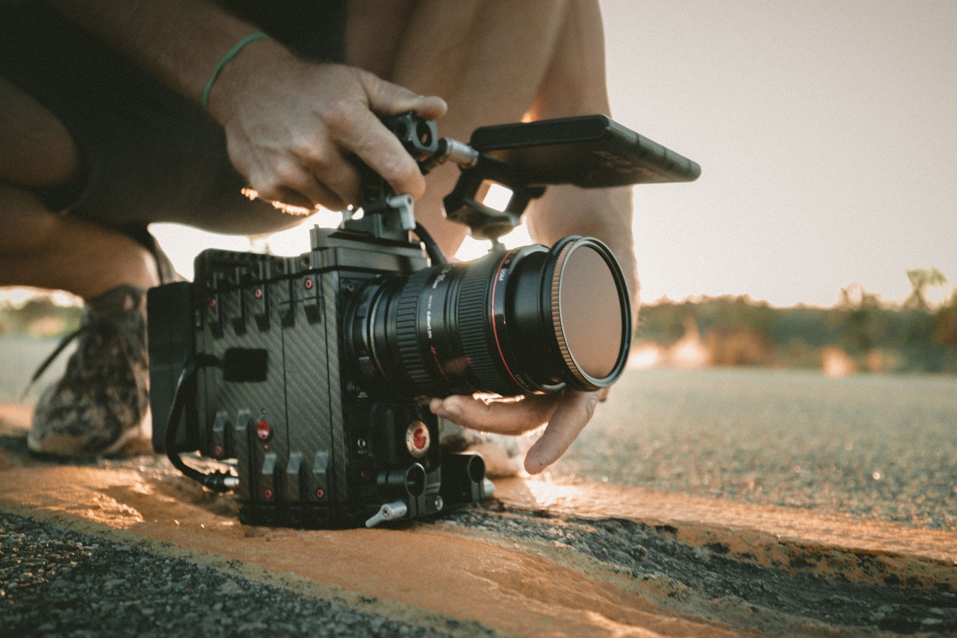 Handheld low angle of a camera operator holding a RED cinema camera