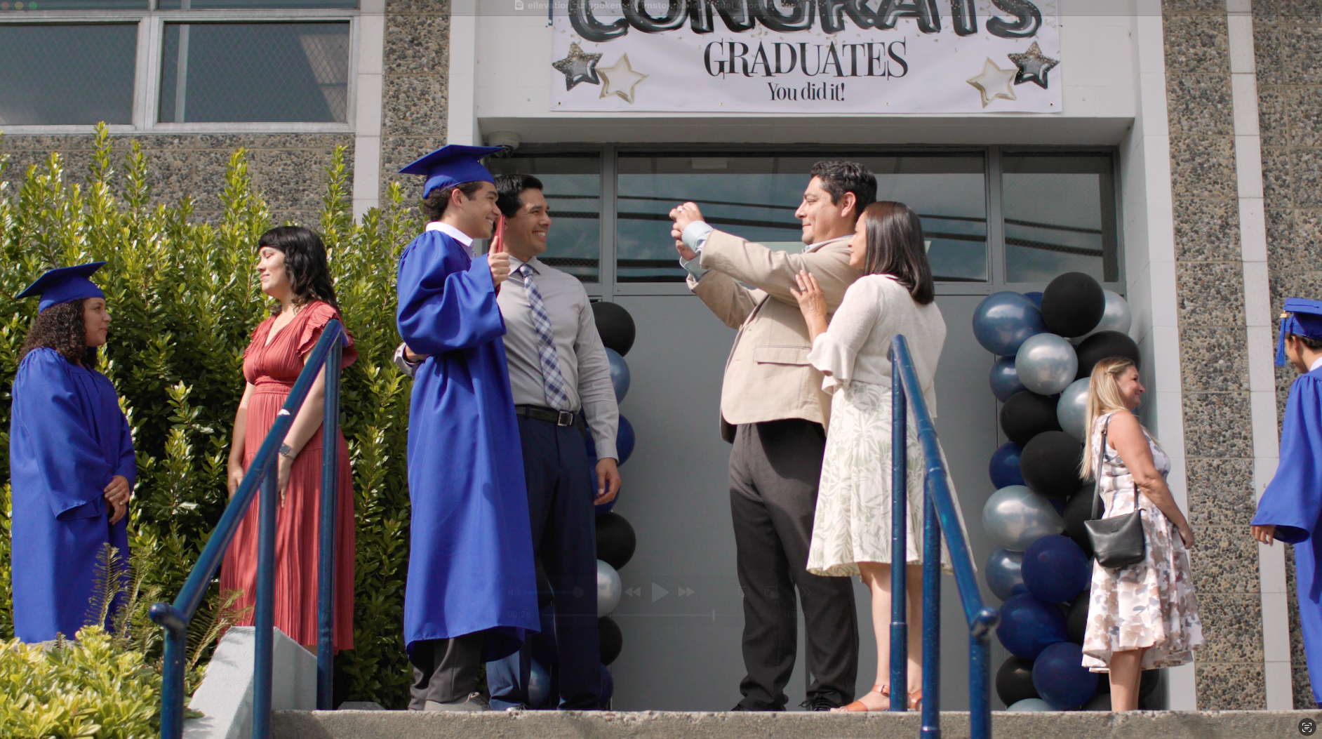A man wearing glasses is holding a pen in his hand.