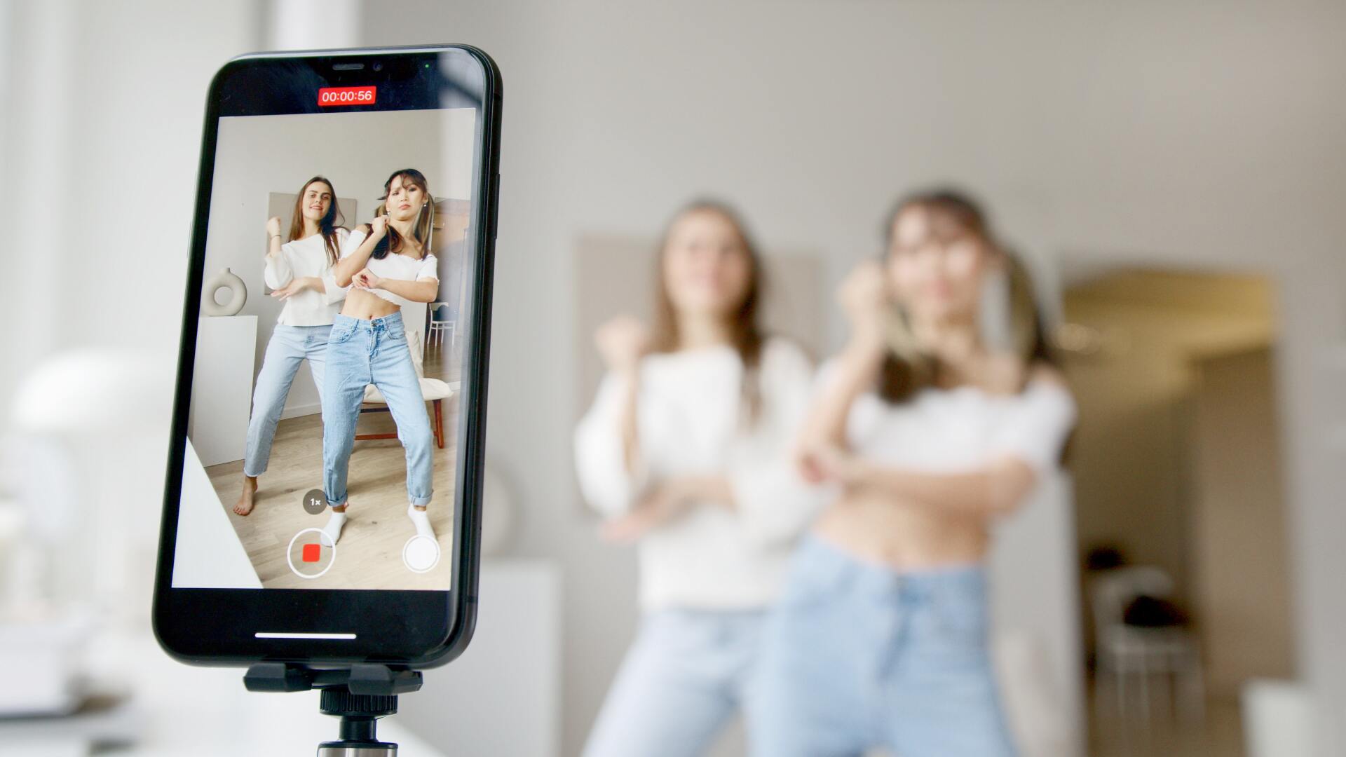 Women dancing in front of mobile phone for instagram social video