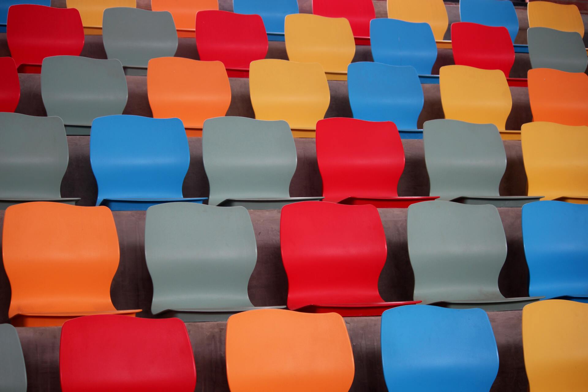 Repeating rows of colored audience chairs