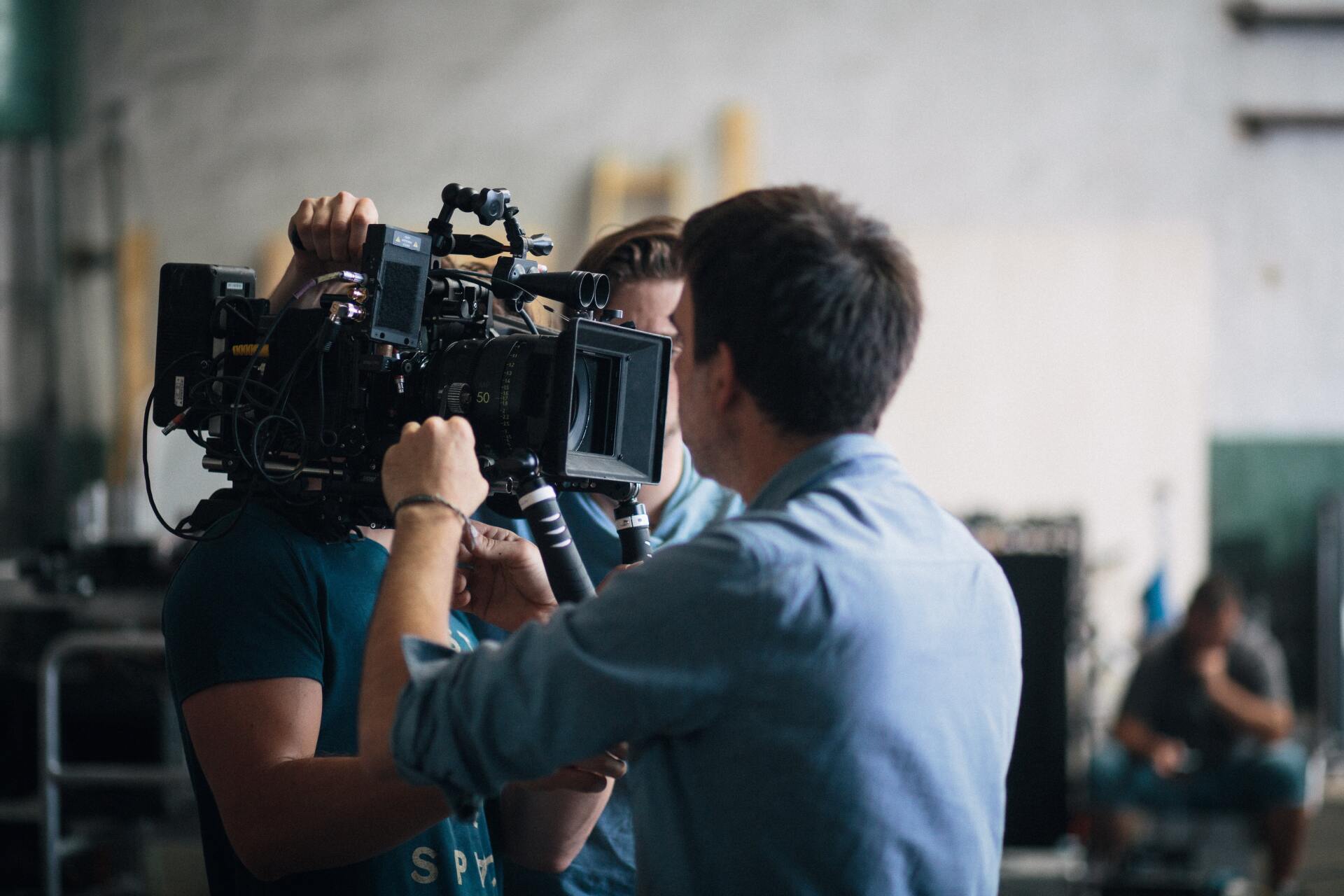 Behind the scenes crew rigging a cinema camera package handheld