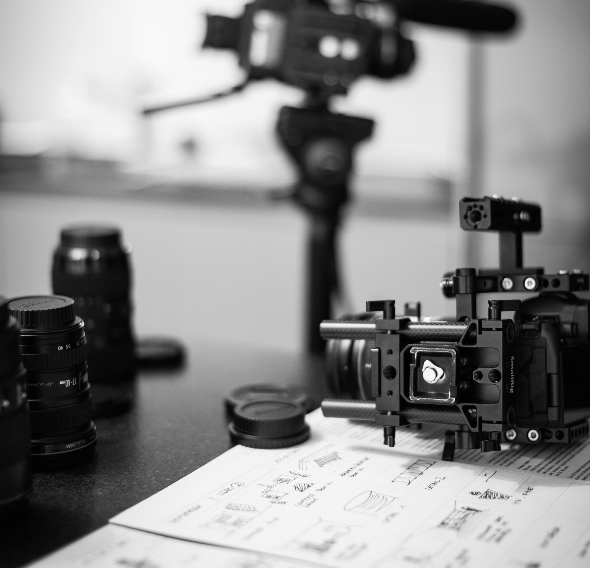 A black and white photo of a camera on a table