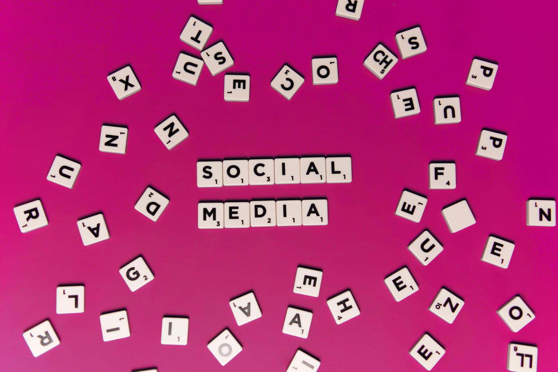 social media words written as scrabble letters over pink background