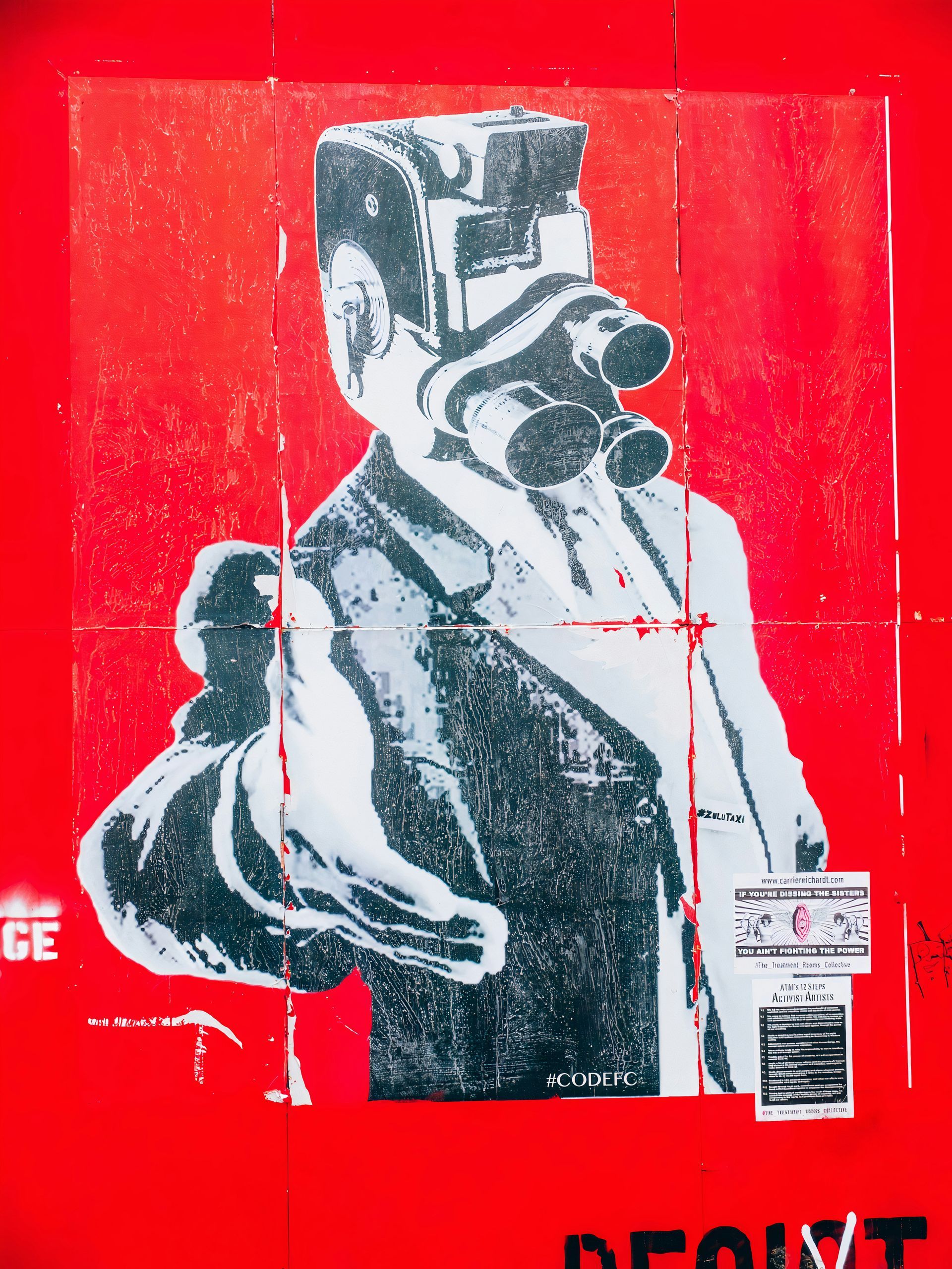 Street art of a person wearing a gas mask, red background, pointing, holding a bag.