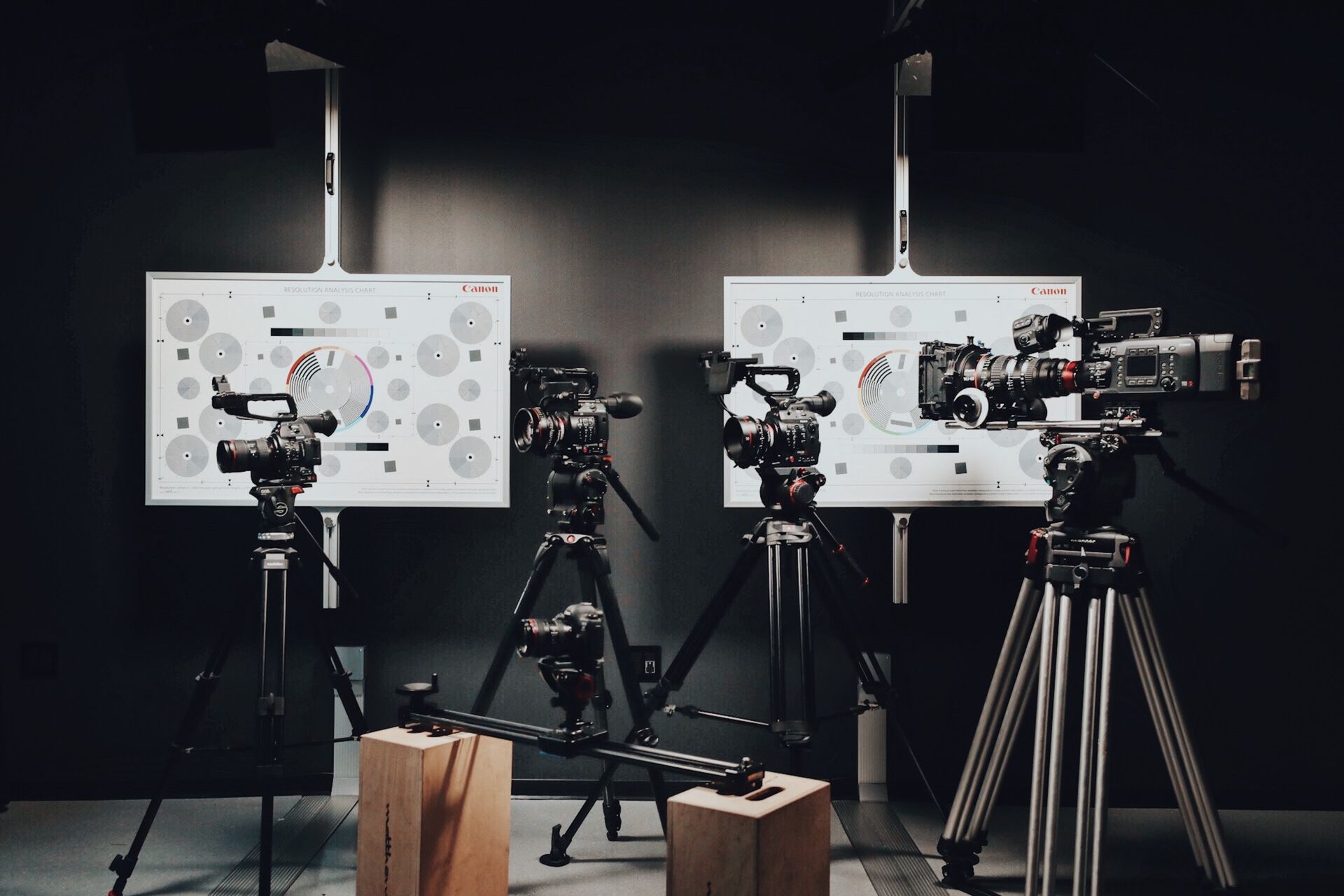 Multiple cinema cameras on tripods in studio