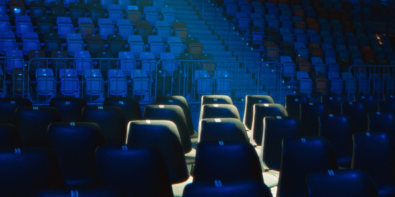 Empty arena seating illuminated by blue light. Empty arena seating illuminated by blue light.