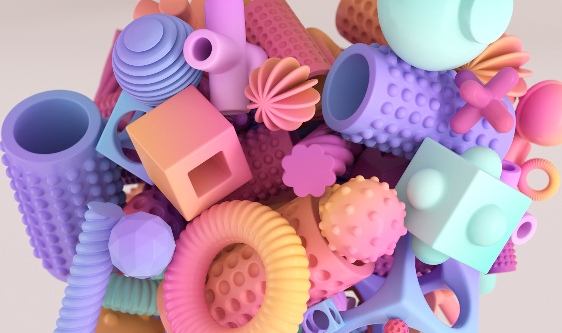 A collection of matte, pastel-colored geometric shapes and textured abstract objects piled together.