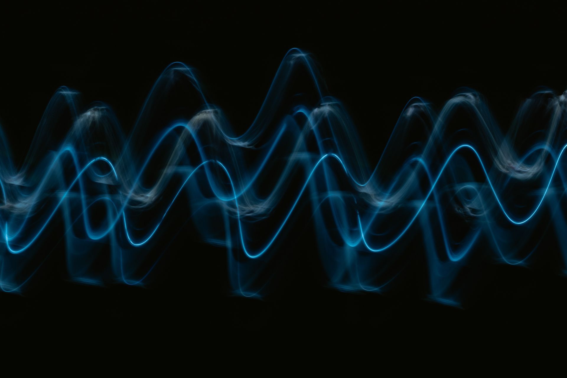Blue sound waves over black background